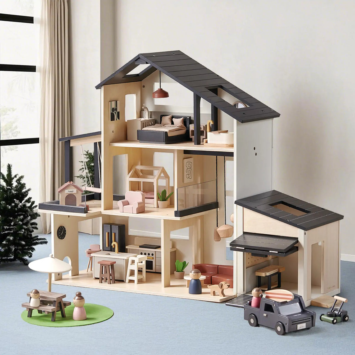 Tiny Land INC wooden dollhouse garage with dark gray roof and detailed interior furniture on Tampa Home & Garden Store
