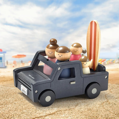 Tiny Land wooden dollhouse garage with smiling dolls in a dark gray vehicle and surfboard on Tampa Home & Garden Store