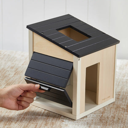Tiny Land wooden dollhouse garage roof panel in dark gray with slatted shingles being installed on Tampa Home & Garden Store