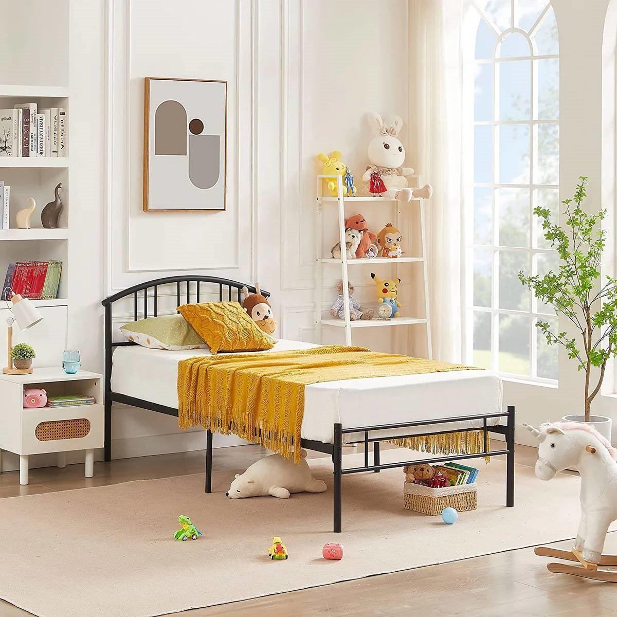 Twin size black metal platform bed frame with arched headboard in a bright kids' room on Tampa Home & Garden Store