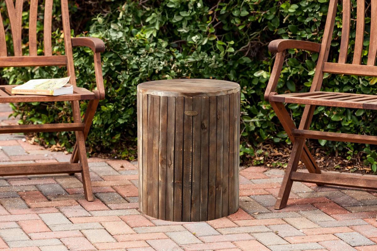 Michael Round Garden Stool round wooden outdoor pouf with vertical slats in weathered brown flanked by two wooden chairs on Tampa Home & Garden Store