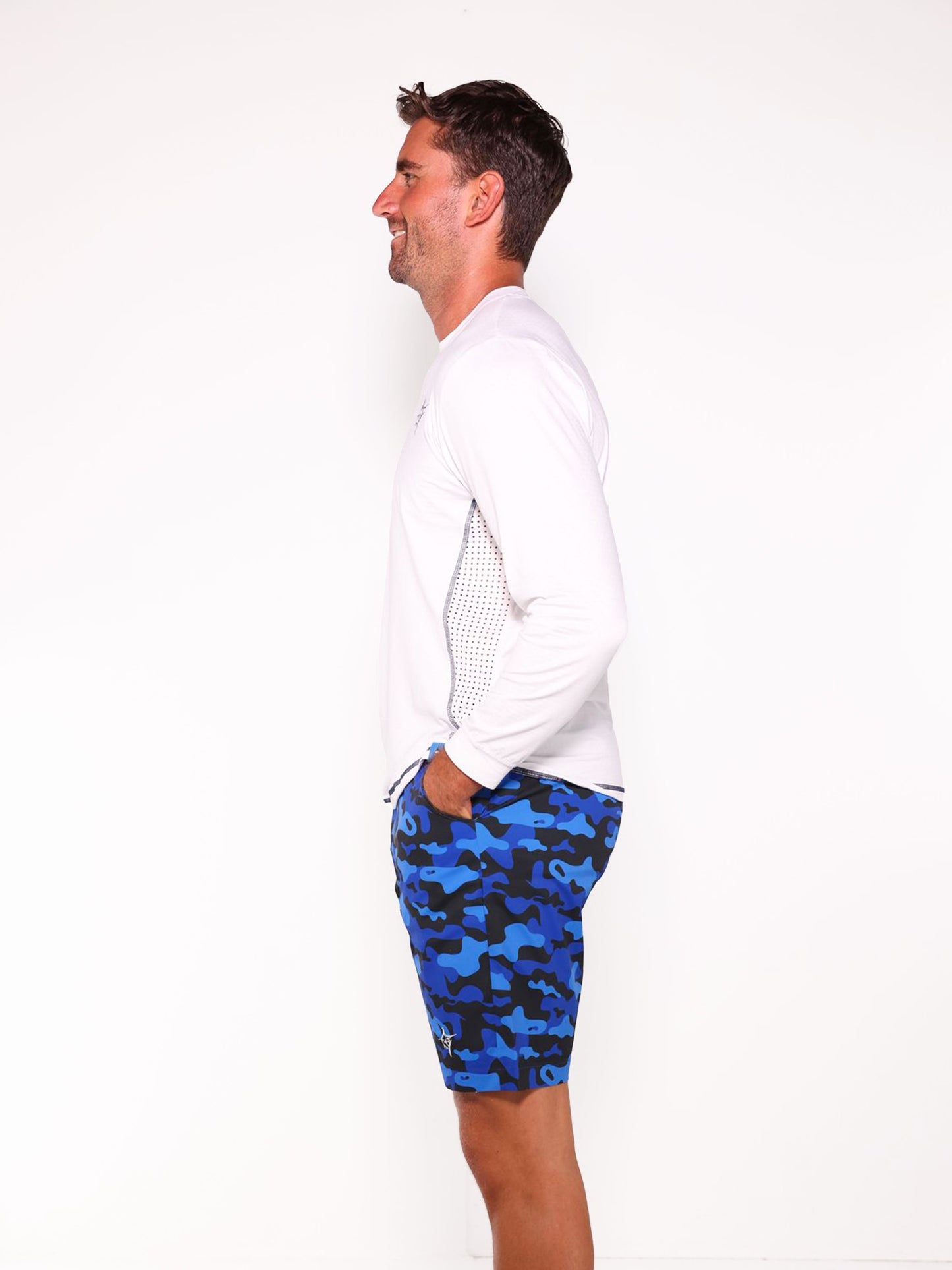 NautiFlex Performance Tee white with mesh side panels; man wearing blue camo shorts on Tampa Home & Garden Store