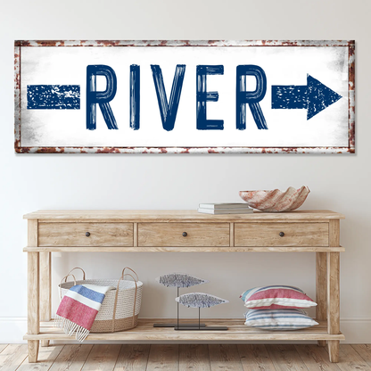 Canvas River Arrow Sign by Tailored Canvases, blue bold lettering with rustic rust frame on Tampa Home & Garden Store
