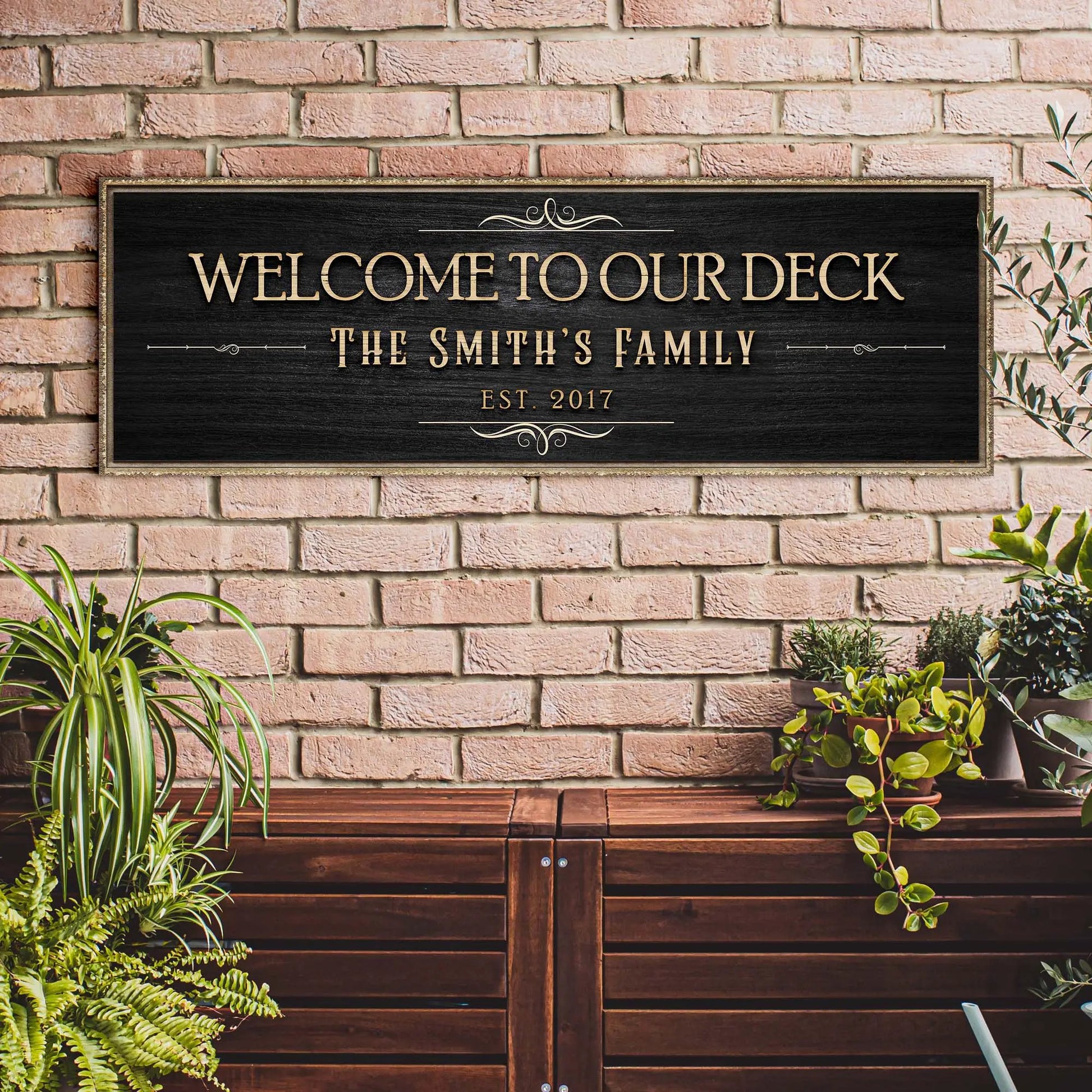 Welcome To Our Deck canvas sign by Tailored Canvases with gold lettering on black plaque on Tampa Home & Garden Store