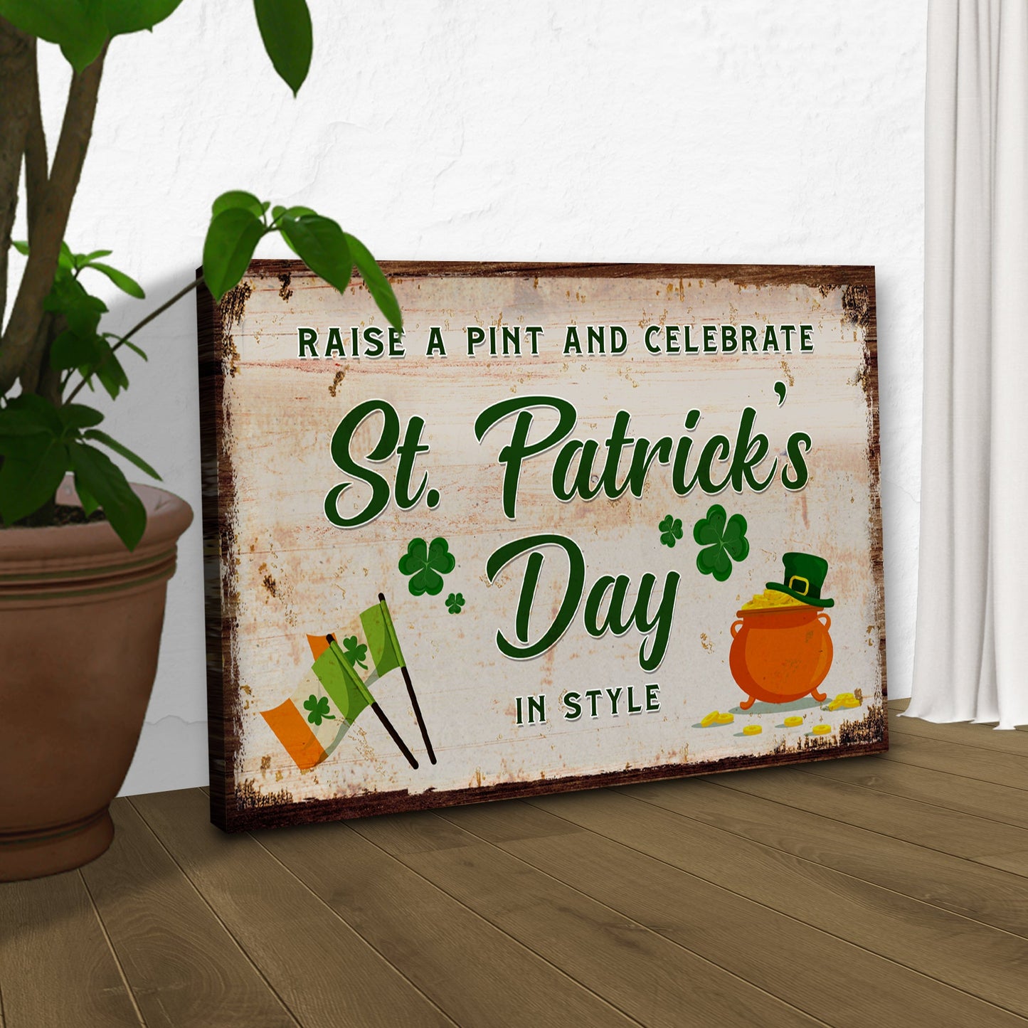 Canvas sign with rustic frame Raise a Pint and Celebrate St Patrick's Day in Style with green text on Tampa Home & Garden Store