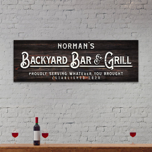 Canvas sign Backyard Bar & Grill on dark wood with lettering on Tampa Home & Garden Store