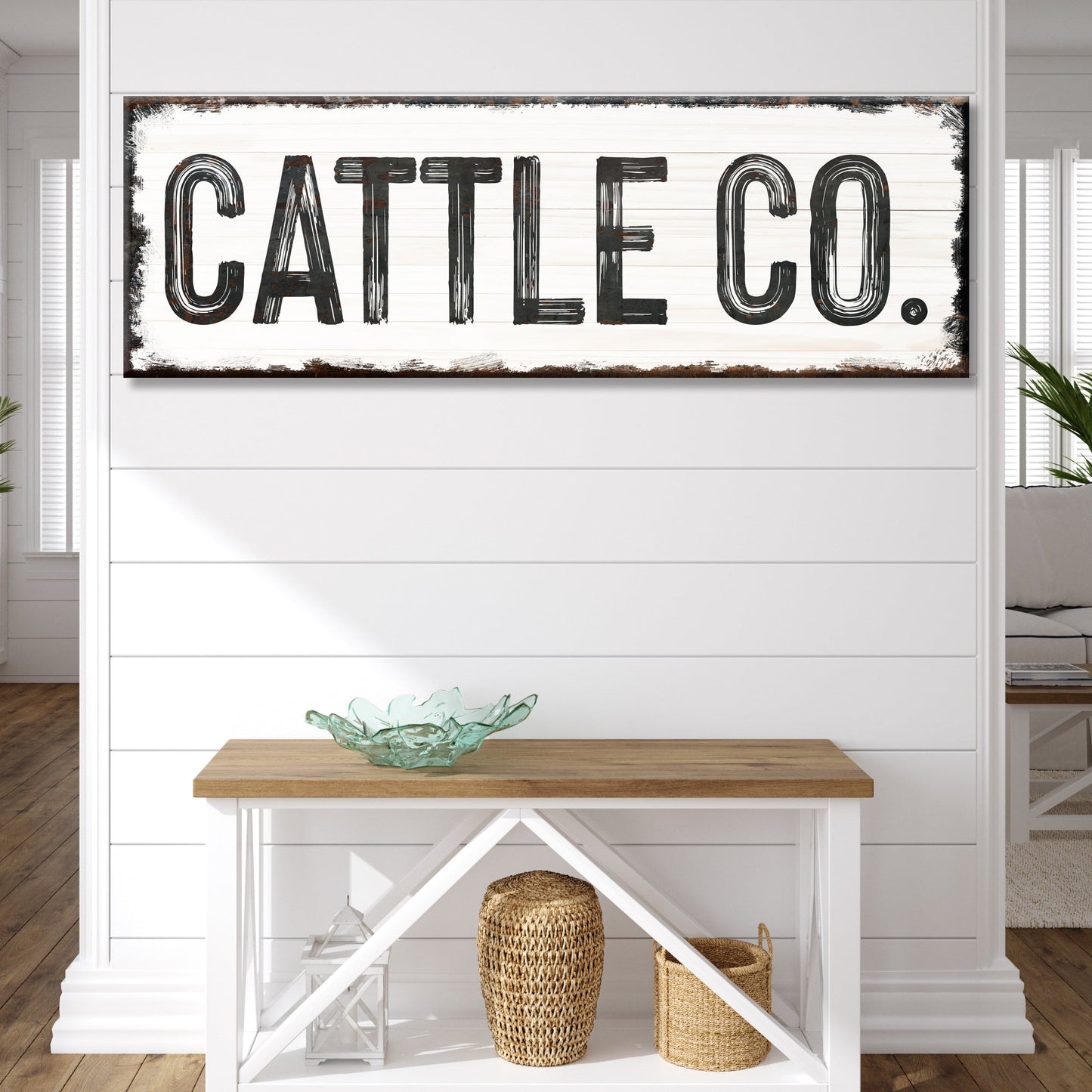Cattle Co canvas sign with distressed black lettering on whitewashed wood backdrop on Tampa Home & Garden Store