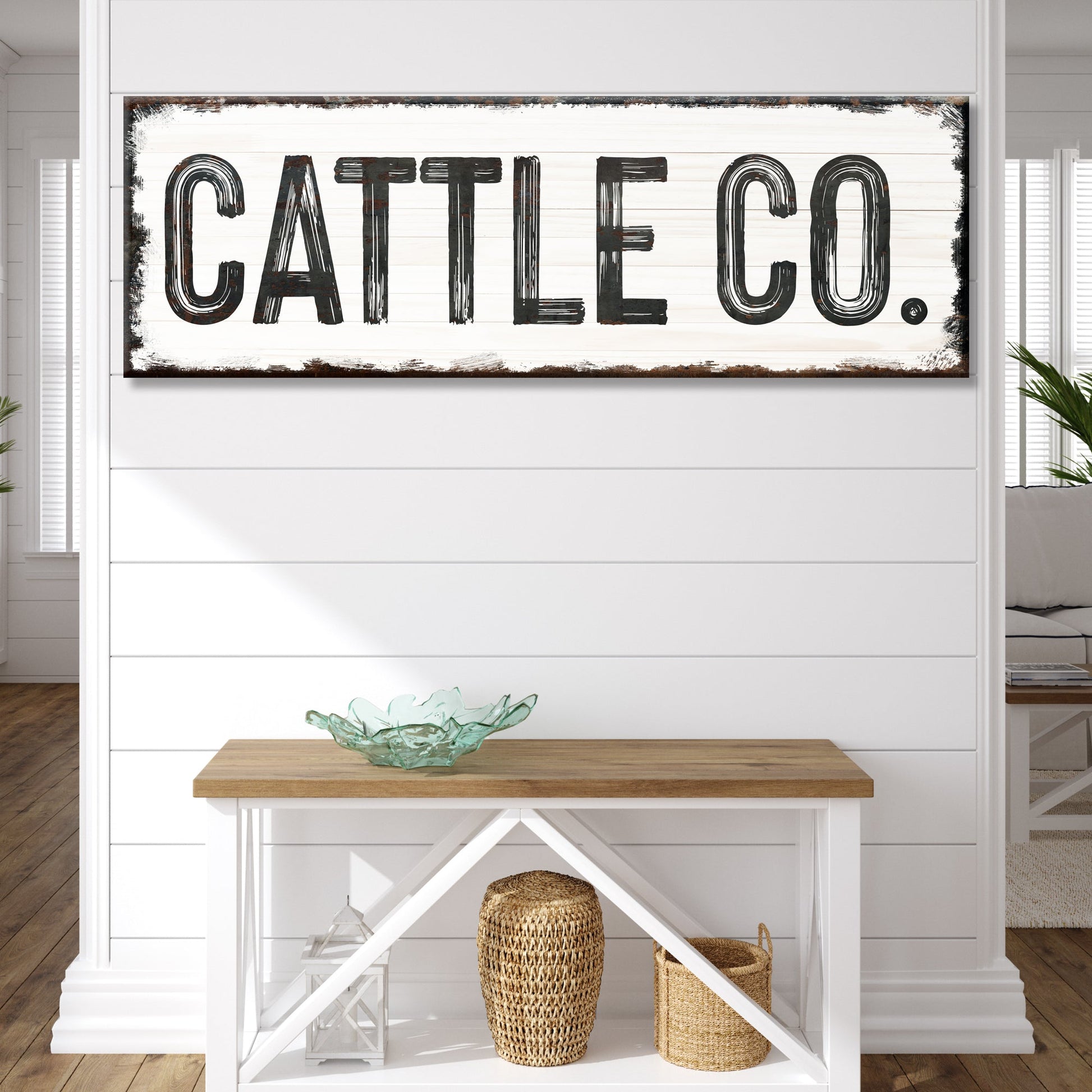 Cattle Co canvas sign with distressed black lettering on whitewashed wood backdrop on Tampa Home & Garden Store