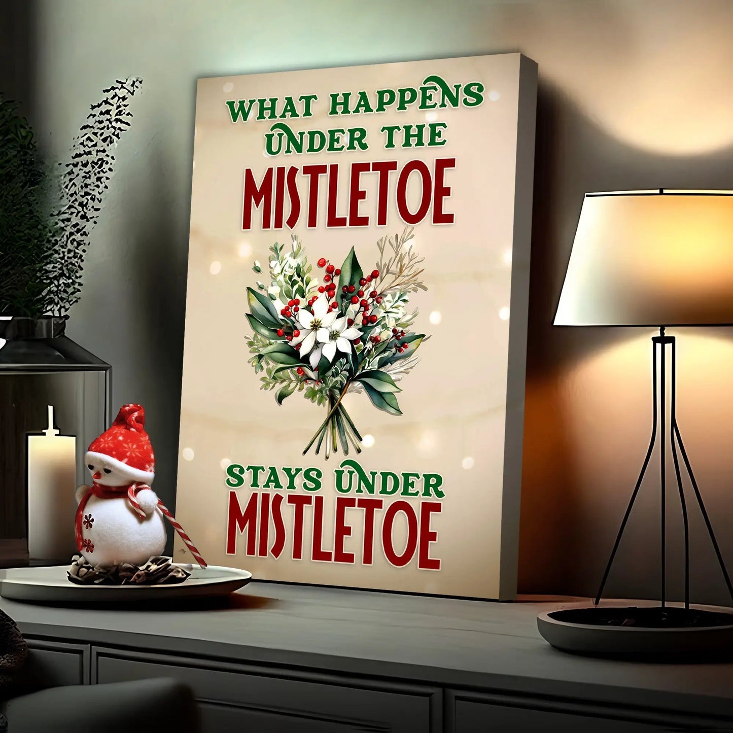 Canvas sign reads What Happens Under The Mistletoe Stays Under Mistletoe with festive bouquet on Tampa Home & Garden Store