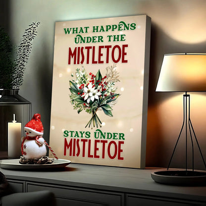 Canvas sign reads What Happens Under The Mistletoe Stays Under Mistletoe with festive bouquet on Tampa Home & Garden Store