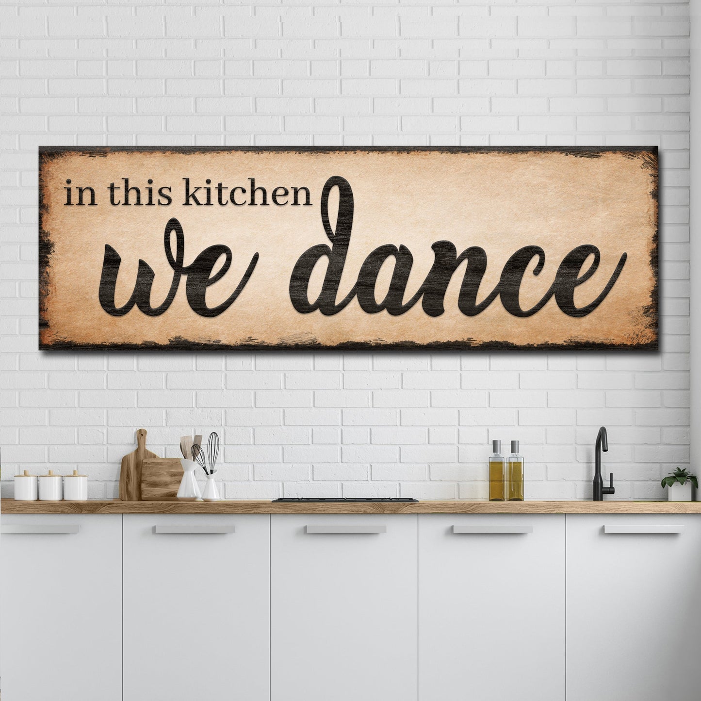 Tailored Canvases canvas sign In This Kitchen We Dance III with parchment on white brick wall on Tampa Home & Garden Store