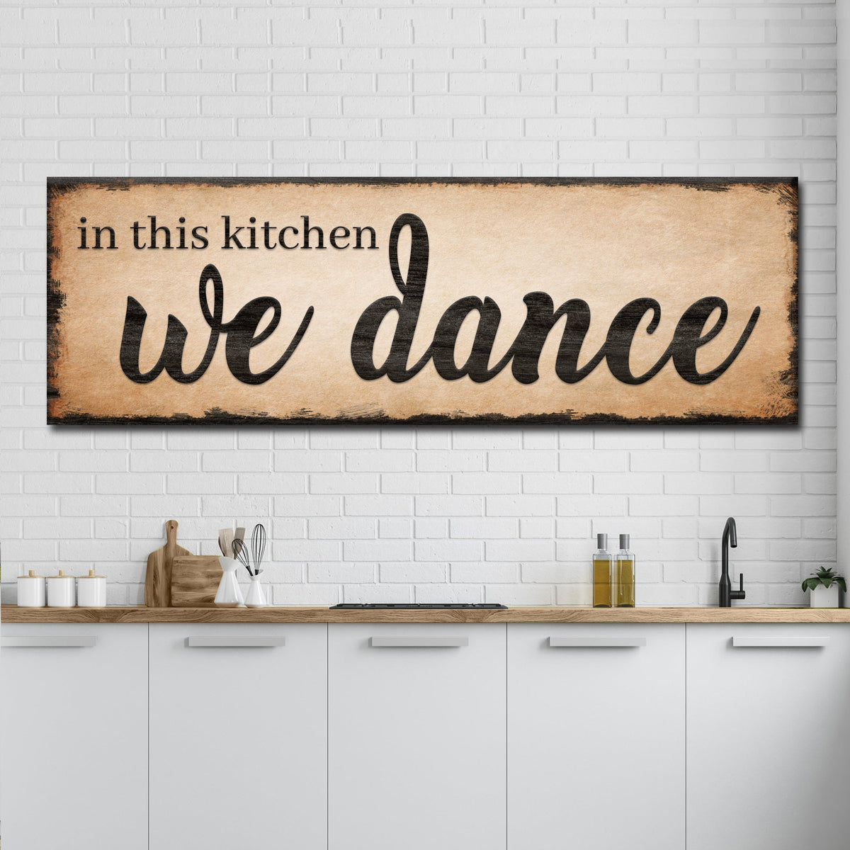 Tailored Canvases canvas sign In This Kitchen We Dance III with parchment on white brick wall on Tampa Home & Garden Store