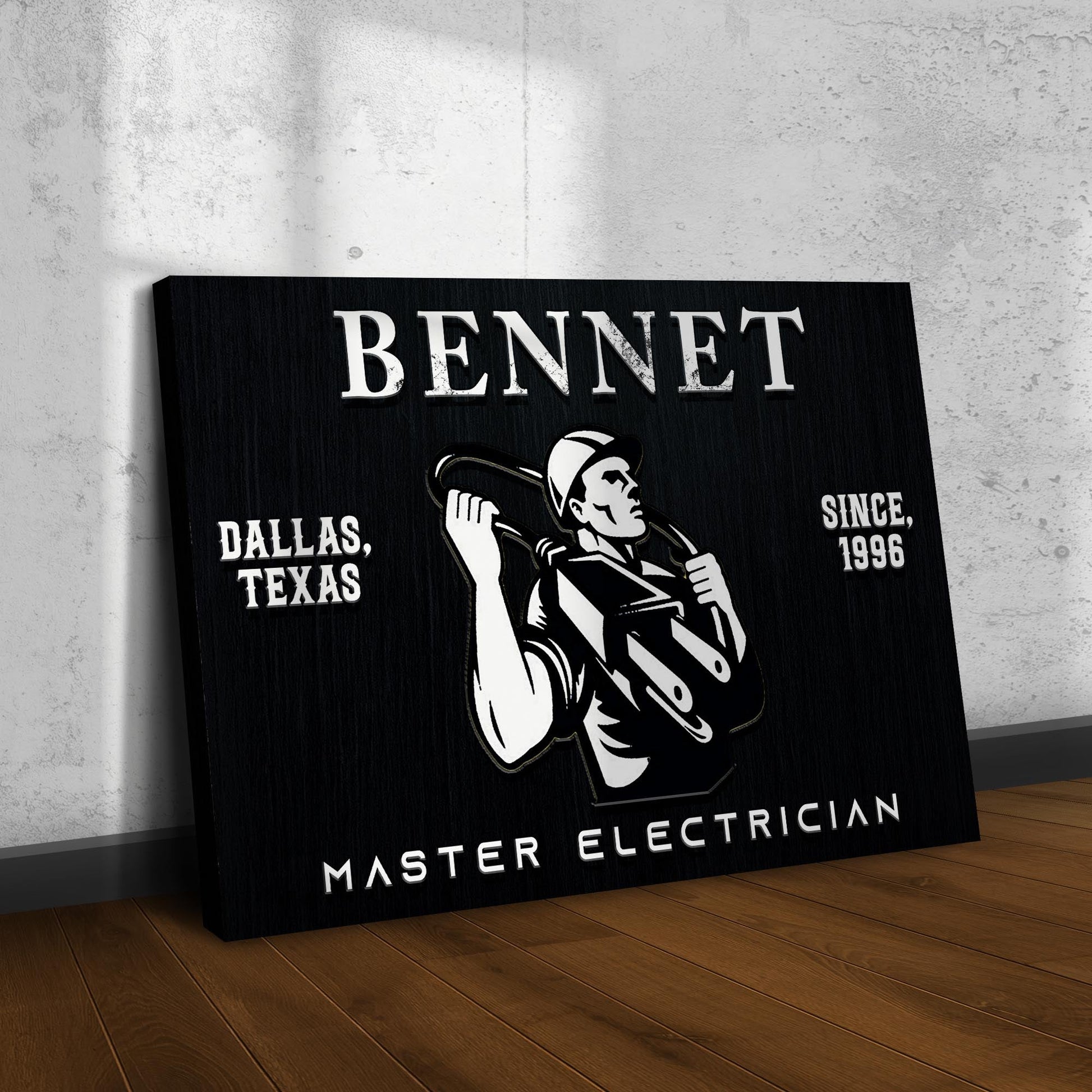 Master Electrician Sign canvas in black with white BENNET lettering and worker illustration on Tampa Home & Garden Store