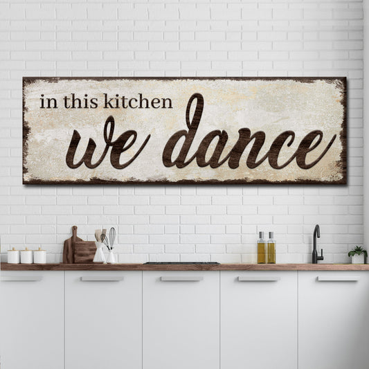 Canvas sign In This Kitchen We Dance with a distressed beige background and brown script on Tampa Home & Garden Store