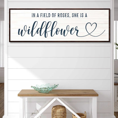 Canvas sign She Is A Wildflower II; navy cursive wildflower on white planked panel with frame on Tampa Home & Garden Store
