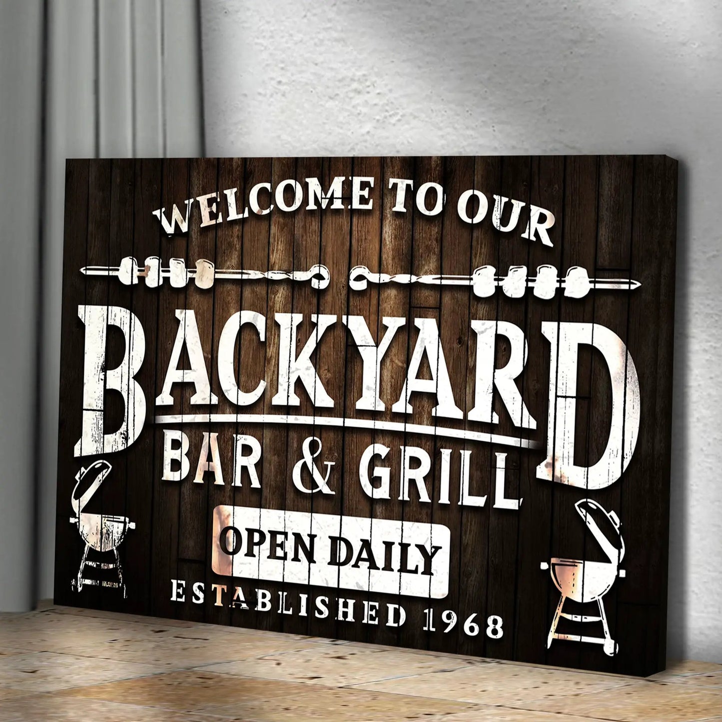 Welcome To Our Backyard Bar And Grill Sign canvas on dark wood with white lettering on Tampa Home & Garden Store
