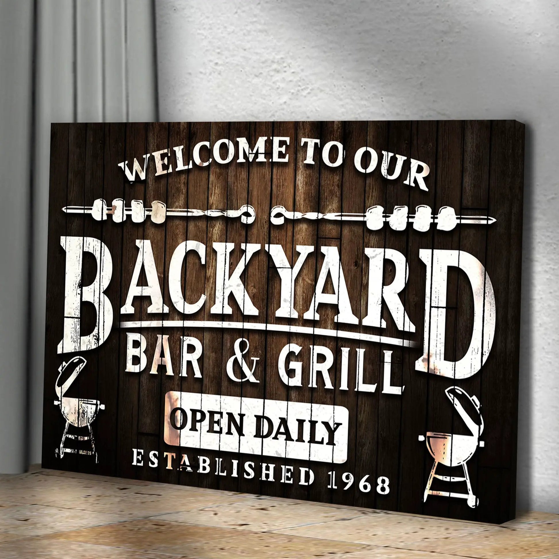Welcome To Our Backyard Bar And Grill Sign canvas on dark wood with white lettering on Tampa Home & Garden Store