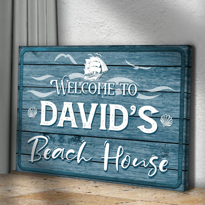 Beach House Welcome Sign canvas on blue distressed wood with white script and shell accents on Tampa Home & Garden Store