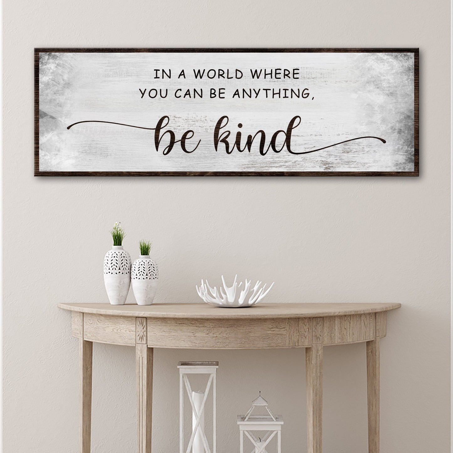 Tailored Canvases be kind canvas sign with distressed white background and dark wood frame on Tampa Home & Garden Store