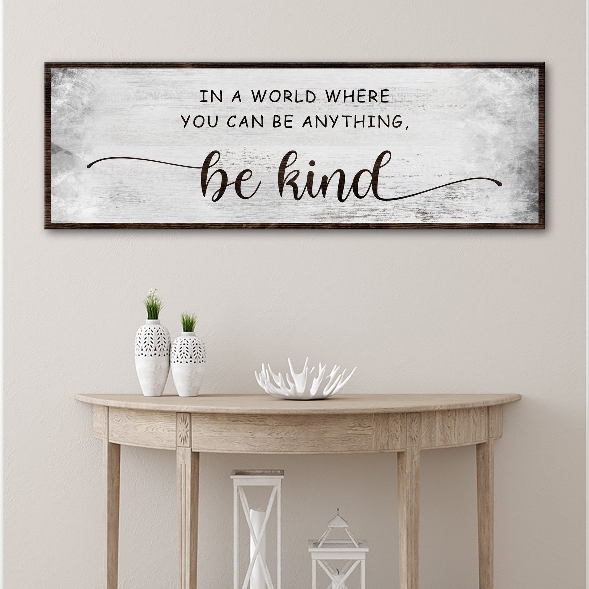 Tailored Canvases be kind canvas sign with distressed white background and dark wood frame on Tampa Home & Garden Store
