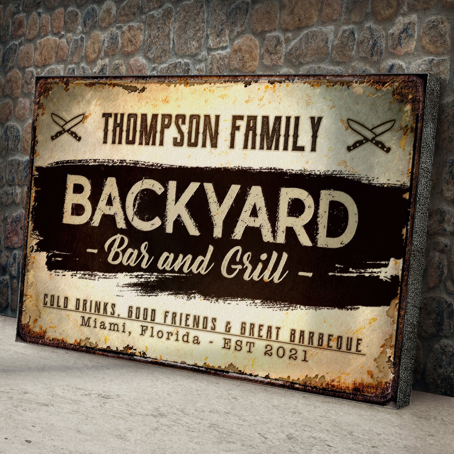 Backyard Bar and Grill canvas sign with vintage typography and knife icons on rustic stone wall on Tampa Home & Garden Store