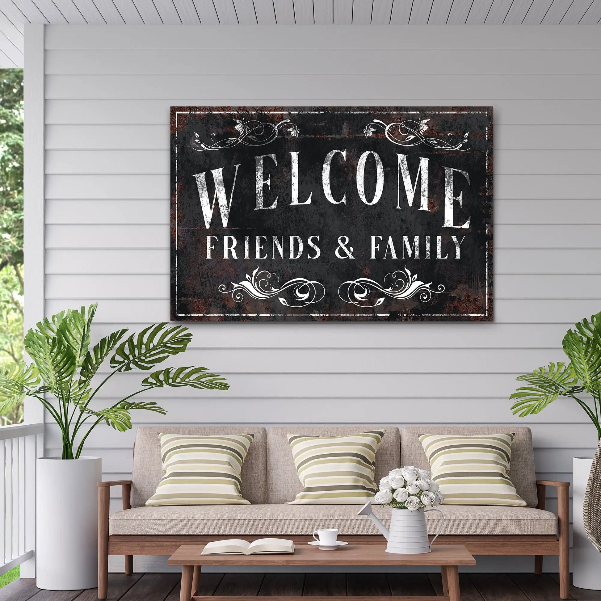 Welcome Friends & Family canvas sign with distressed black background and white ornate scrolls on Tampa Home & Garden Store