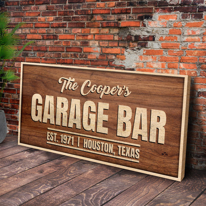 Rustic Garage Bar Wood Sign on a wooden panel leaning against a brick wall with greenery on Tampa Home & Garden Store
