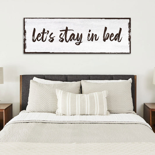 Let's Stay In Bed Sign canvas by Tailored Canvases with white backdrop and brown script on Tampa Home & Garden Store