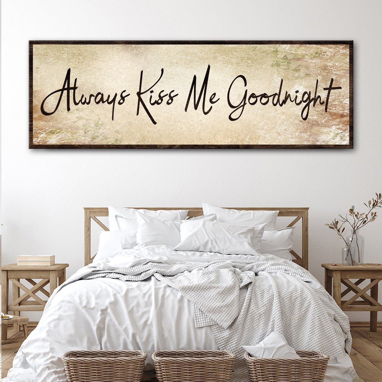 Always Kiss Me Goodnight Sign IV canvas with dark wood frame, beige distressed backdrop and flowing script above a white bed on Tampa Home & Garden Store