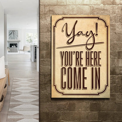 Tailored Canvases entryway canvas sign on brick wall with beige plaque reading Yay! on Tampa Home & Garden Store
