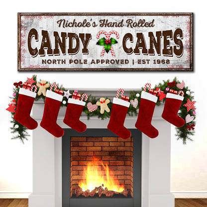 Canvas sign North Pole Candy Canes with rustic wood backdrop and holly accent over a fireplace on Tampa Home & Garden Store
