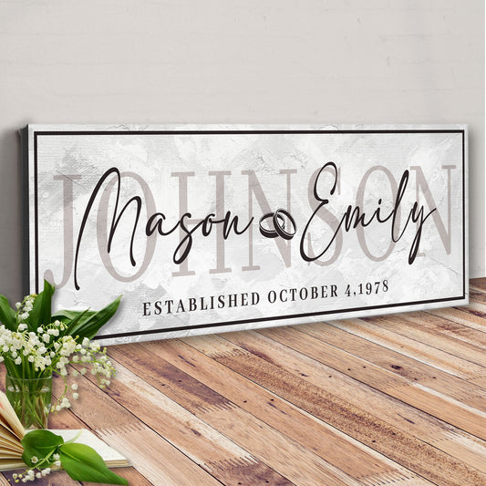 Last Name Wedding Gift Sign canvas with scripted names on backdrop and black border on Tampa Home & Garden Store