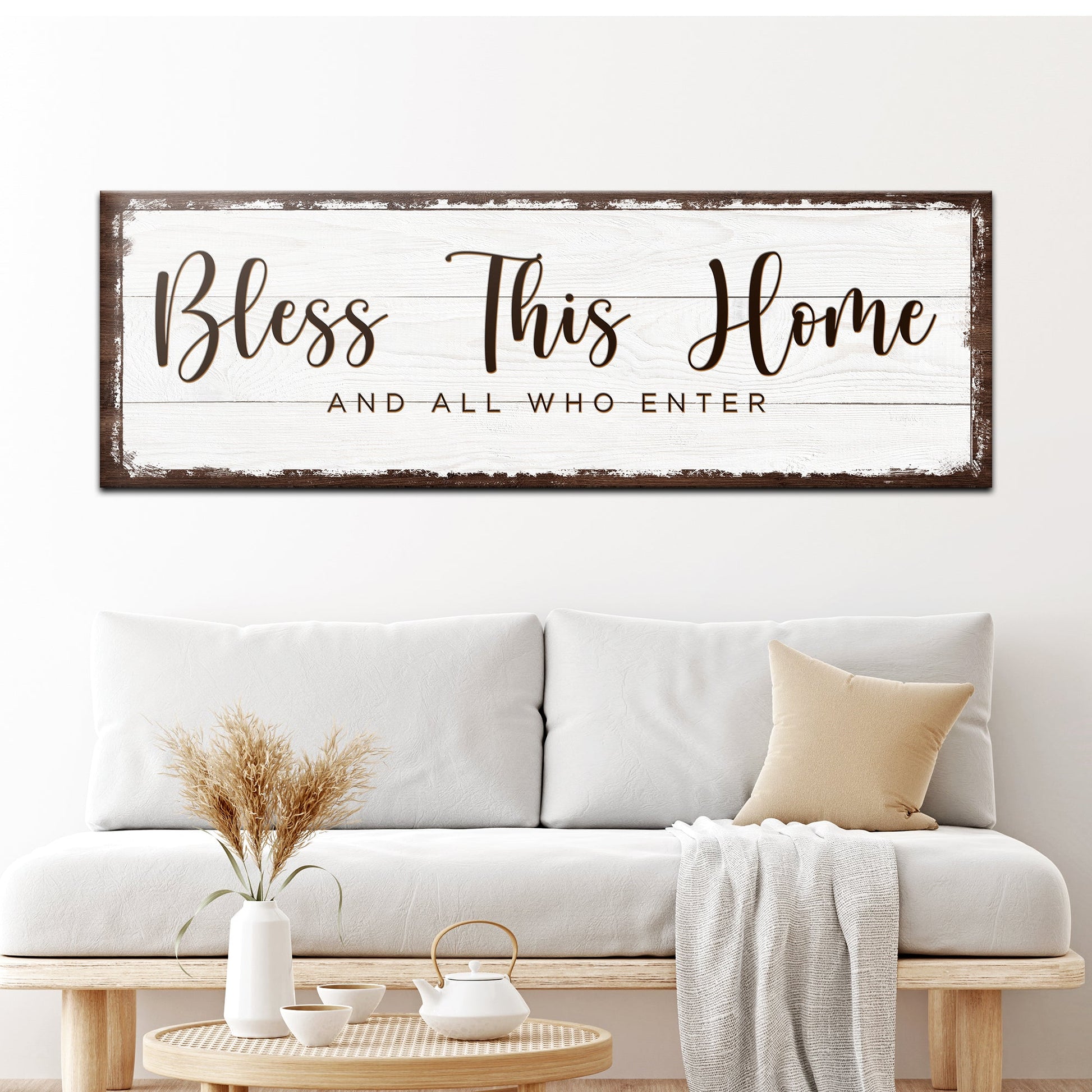 Bless This Home canvas sign with distressed white panel and brown frame in script lettering on Tampa Home & Garden Store