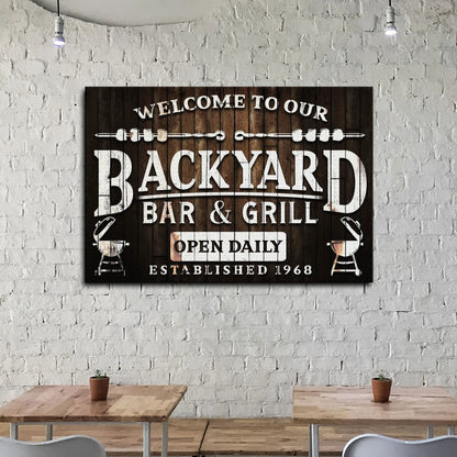 Canvas sign reading Welcome To Our Backyard Bar & Grill on wood planks by Tailored Canvases on Tampa Home & Garden Store