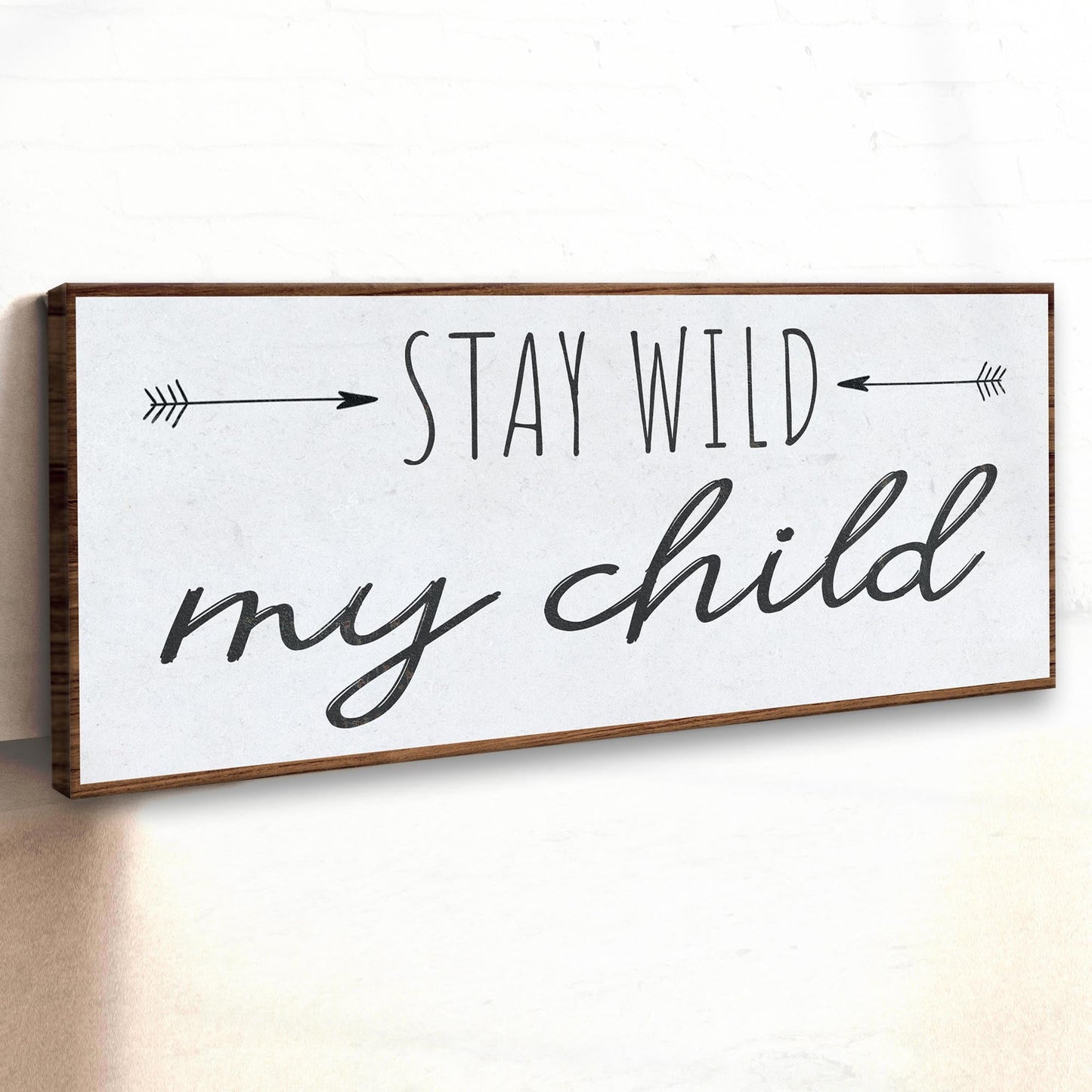 Stay Wild My Child canvas sign by Tailored Canvases, framed wood, black script with arrows on Tampa Home & Garden Store