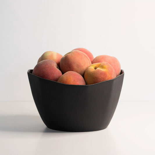 Medium porcelain nesting bowl, Ember Collective, black, filled with peaches on Tampa Home & Garden Store