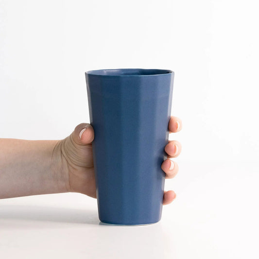Handmade porcelain pint cup in blue held by hands, Ember Collective drinkware on Tampa Home & Garden Store