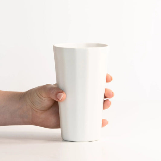 Handmade porcelain pint cup, white ceramic drinkware by Ember Collective, held in hand on Tampa Home & Garden Store