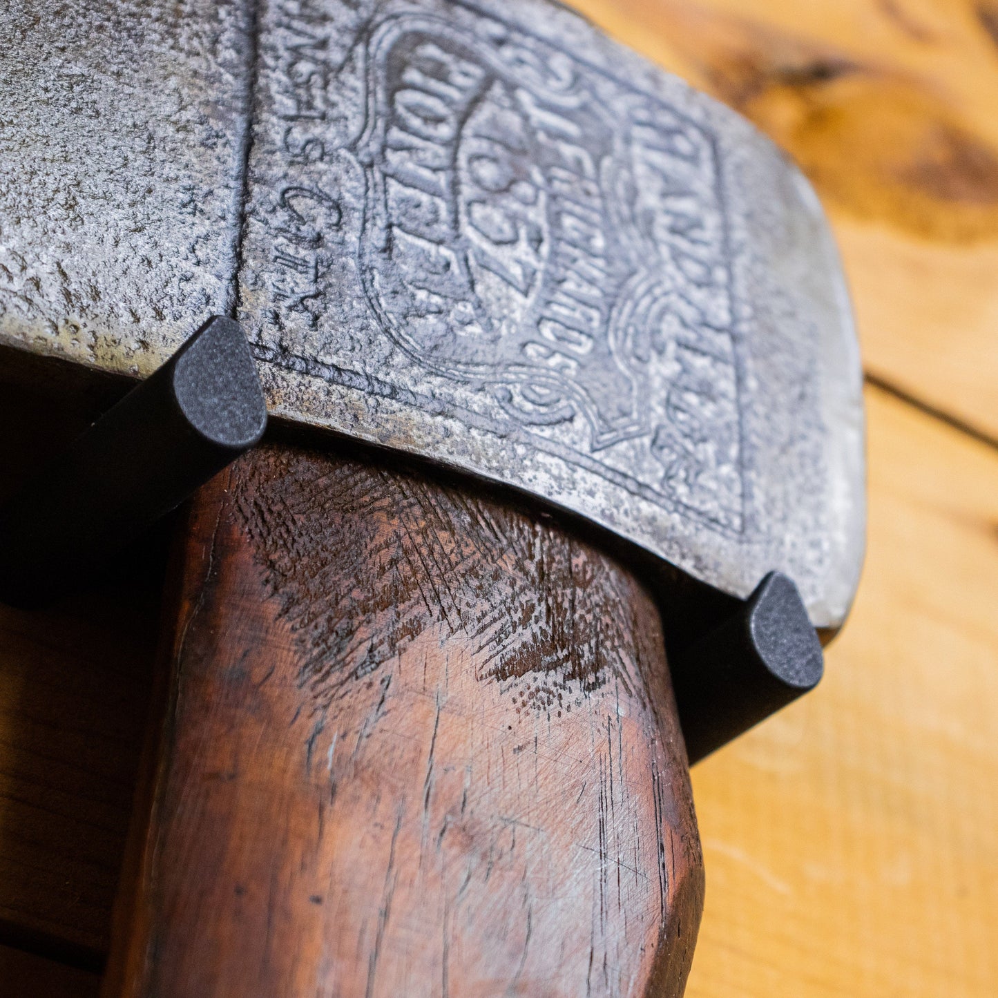 Axe Anchors drywall anchor in gray metal with embossed circular pattern on dark wood post on Tampa Home & Garden Store