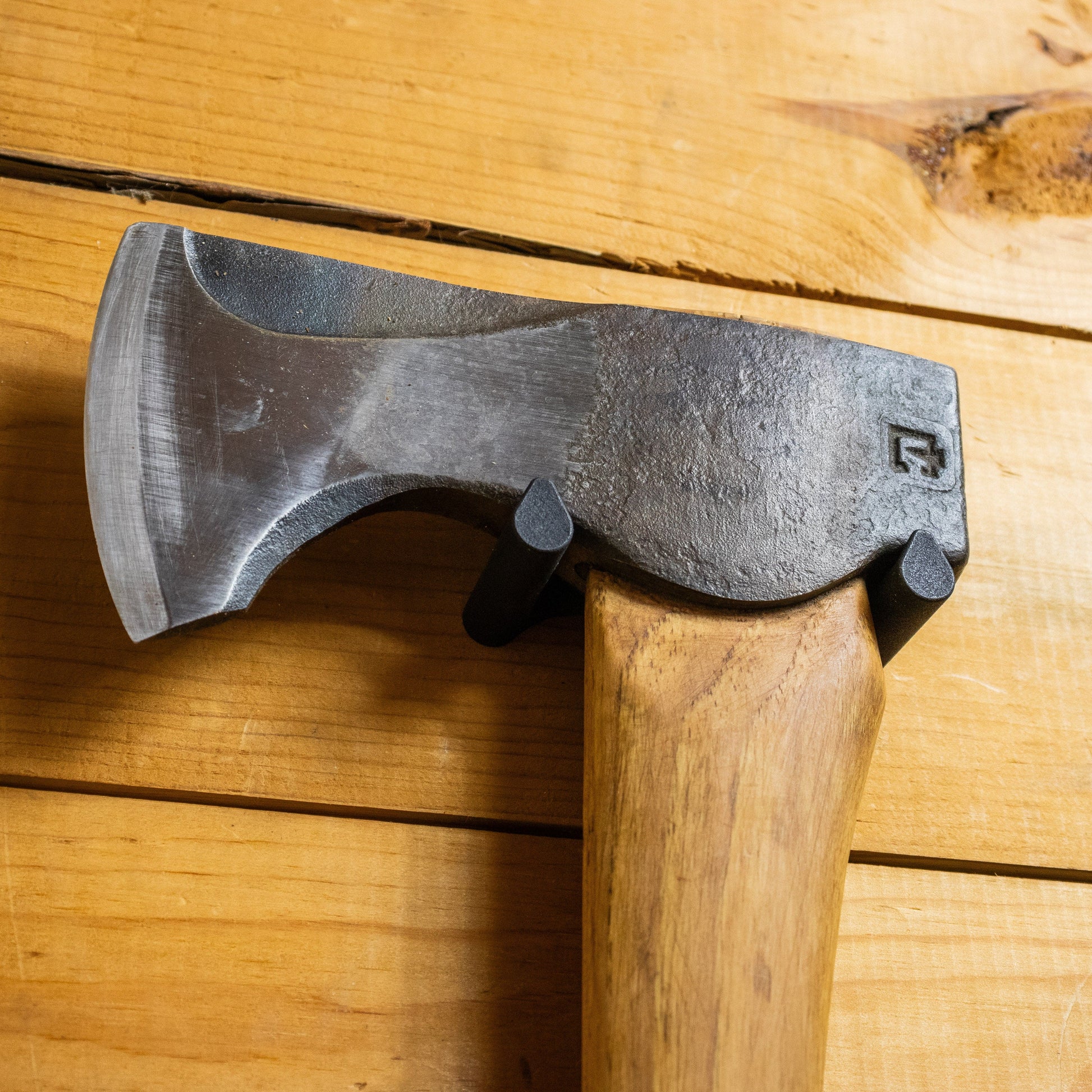 Axe Anchors drywall anchor tool close-up: dark metal axe head on wooden handle on Tampa Home & Garden Store