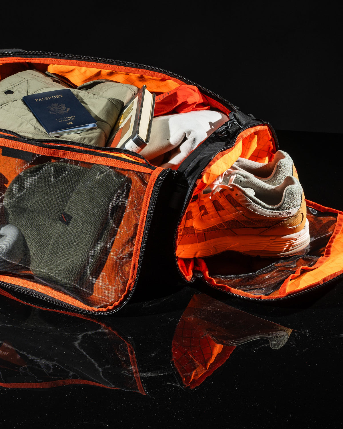 Duffalo duffel bag by The Brown Buffalo, orange inside with passport, jacket and sneakers on Tampa Home & Garden Store