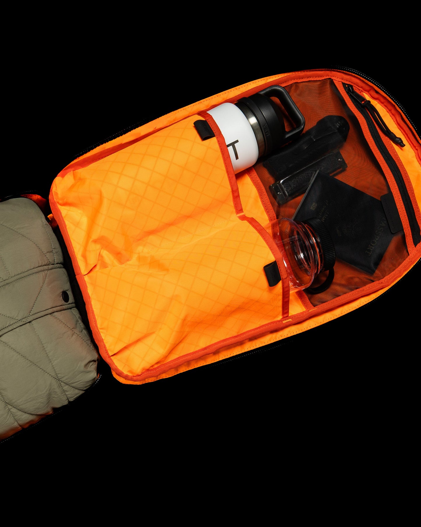Conceal Pack 21L orange backpack featuring water bottle and gear by The Brown Buffalo on Tampa Home & Garden Store
