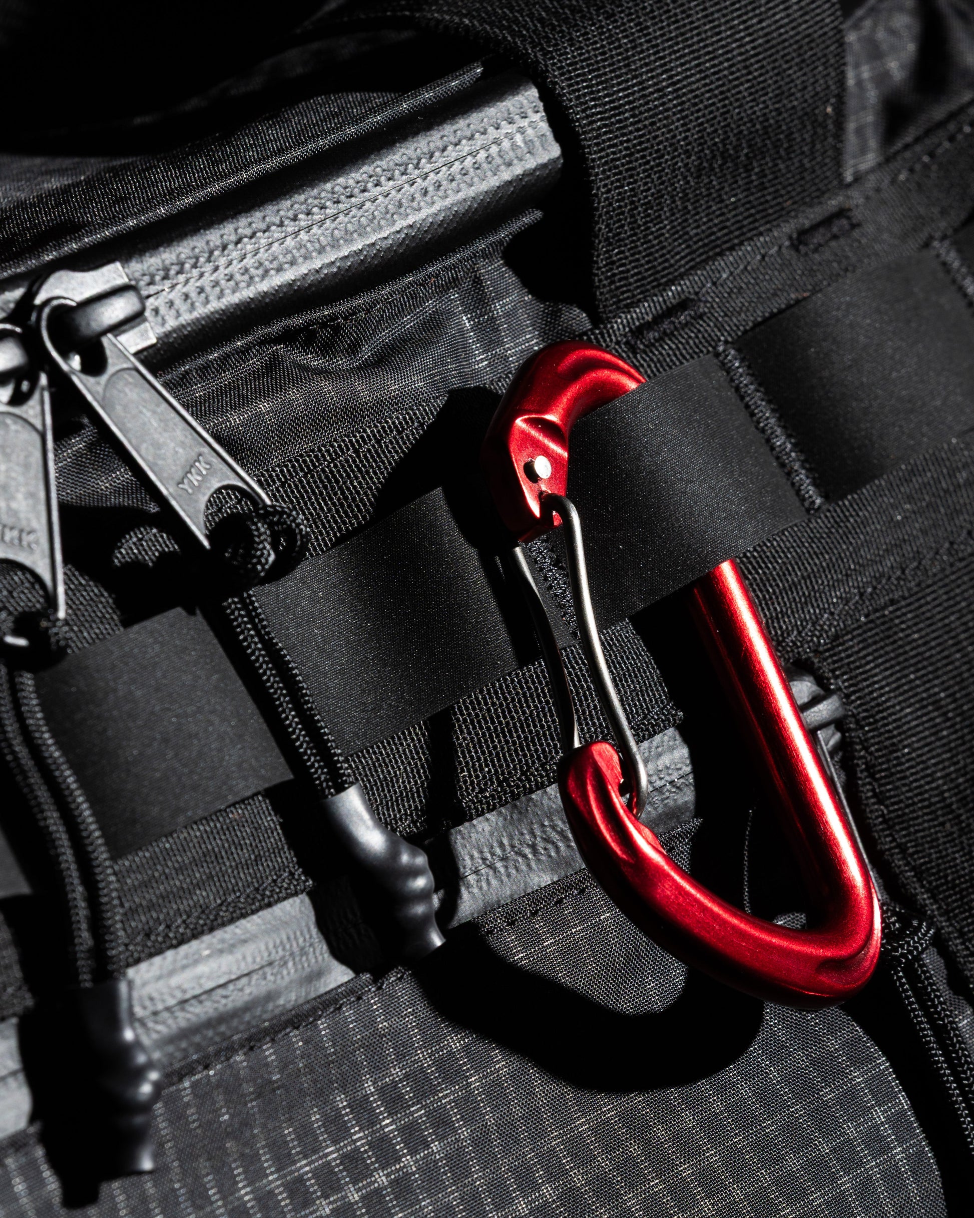 Duffalo duffel bag closeup of black nylon with red carabiner hardware on Tampa Home & Garden Store