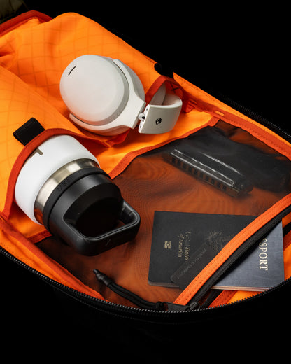 Conceal Pack 21L backpack by The Brown Buffalo with headphones inside bright orange lining on Tampa Home & Garden Store