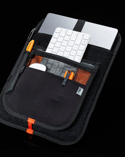 MOD 002 organizer backpack black with orange zippers; holds silver laptop and white keyboard on Tampa Home & Garden Store
