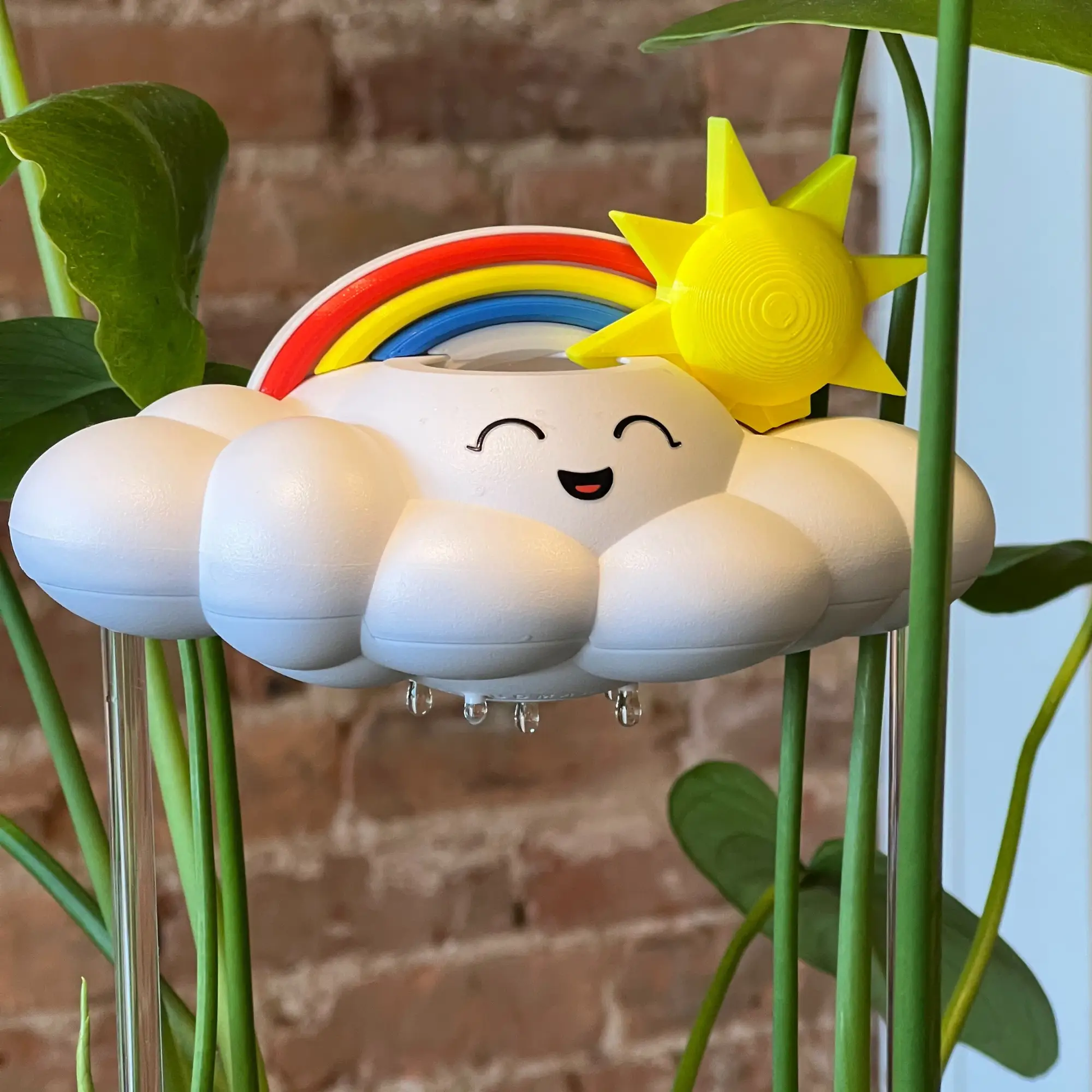 Chelsea the Cloud Plant Pal watering globe on a cloud planter with rainbow and sun accents on Tampa Home & Garden Store