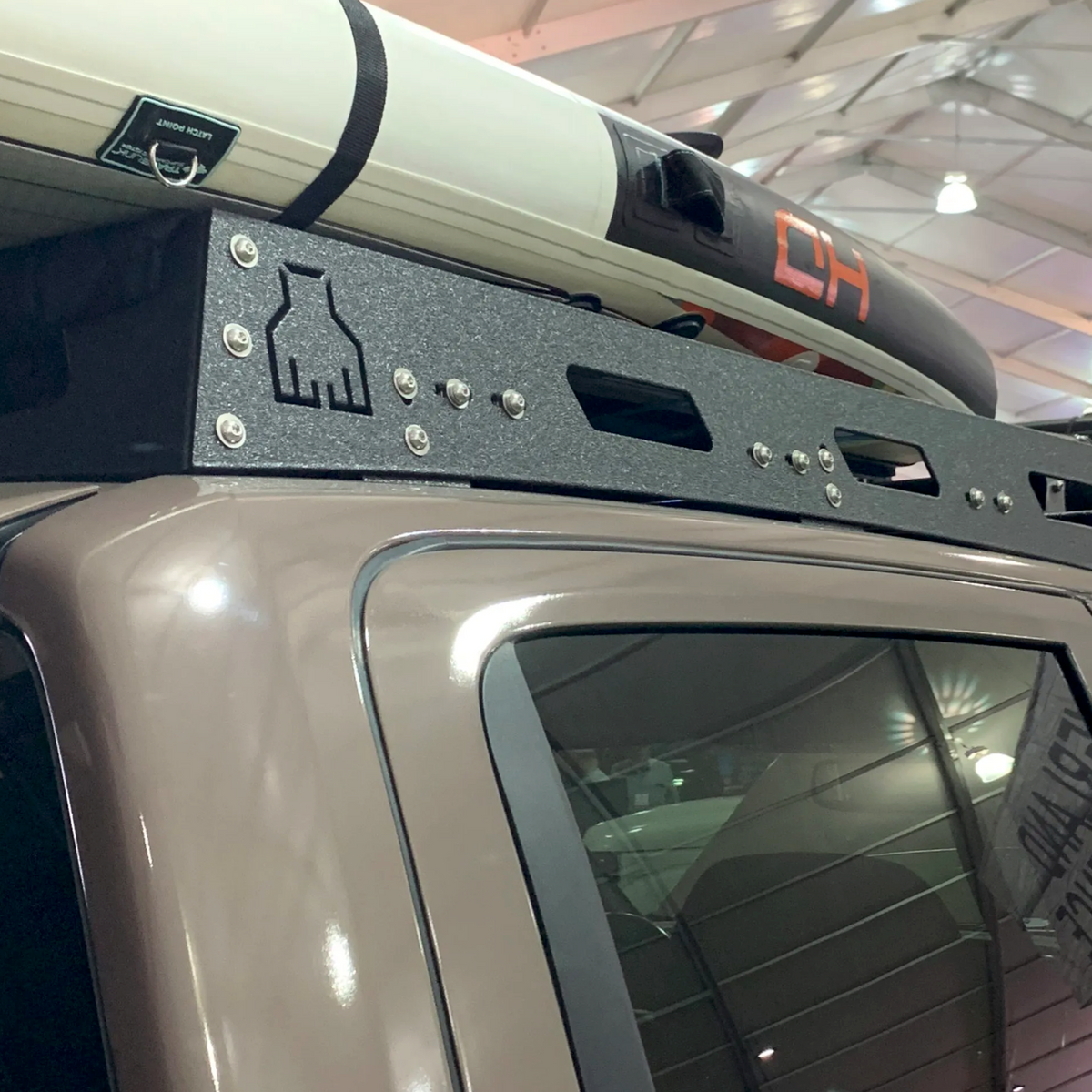 Nissan Titan Roof Rack by Avatar Offroad, black textured steel carrying a white kayak on Tampa Home & Garden Store