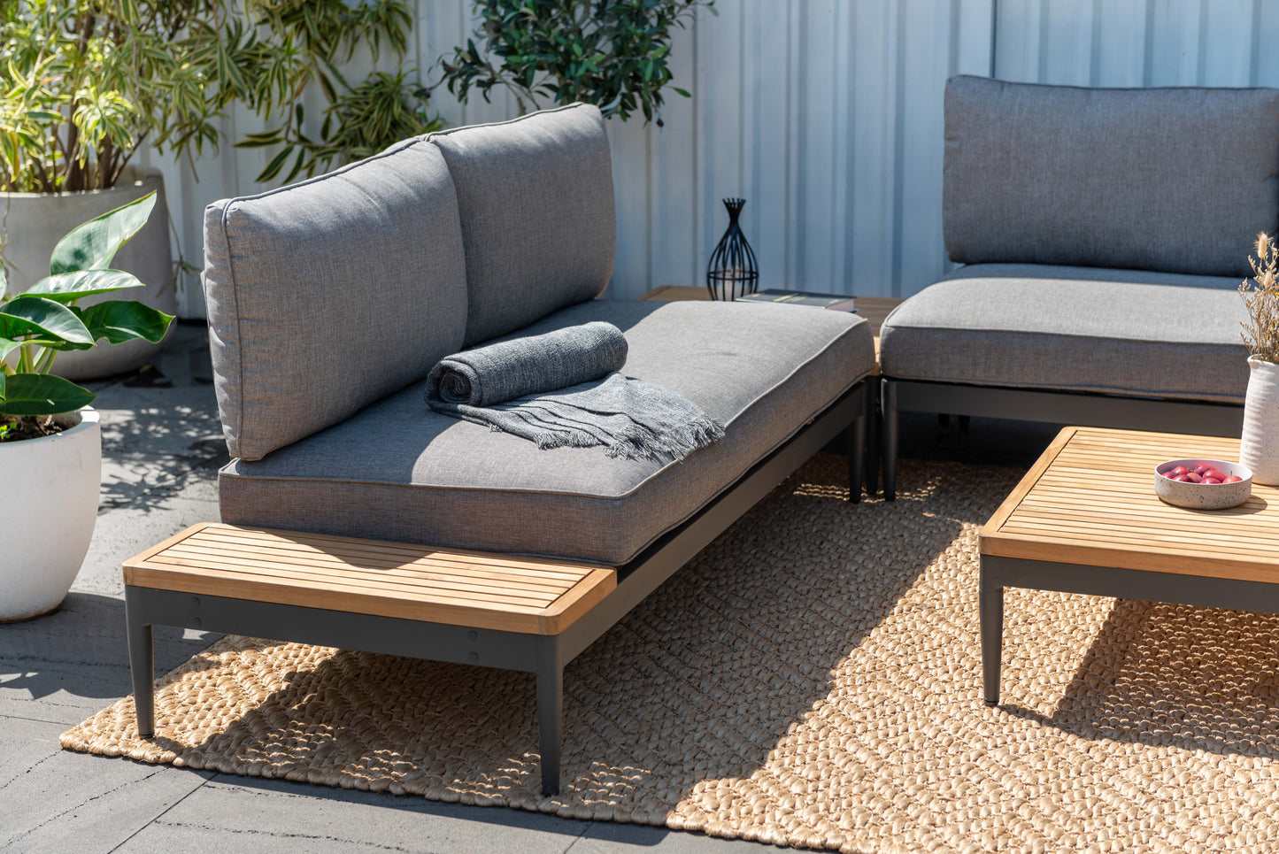 Topaz 2 Seater Sofa from LifestyleGarden US in gray outdoor fabric with rolled blanket on Tampa Home & Garden Store