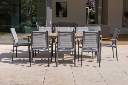 Topaz 9 Piece Teak Rectangular Dining Set with teak tabletop and fabric chairs on patio on Tampa Home & Garden Store