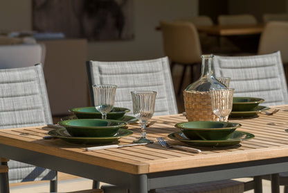 Topaz 9 Piece Teak Rectangular Outdoor Dining Set with green dinnerware on teak table on Tampa Home & Garden Store
